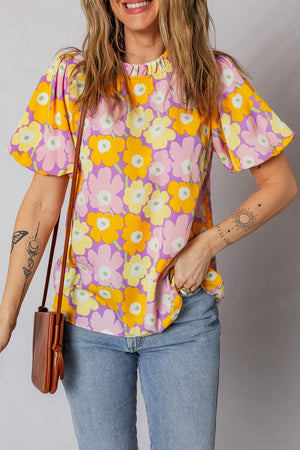 Puff sleeve blouse with ruffle trim in a floral print, featuring short sleeves and a high neckline.