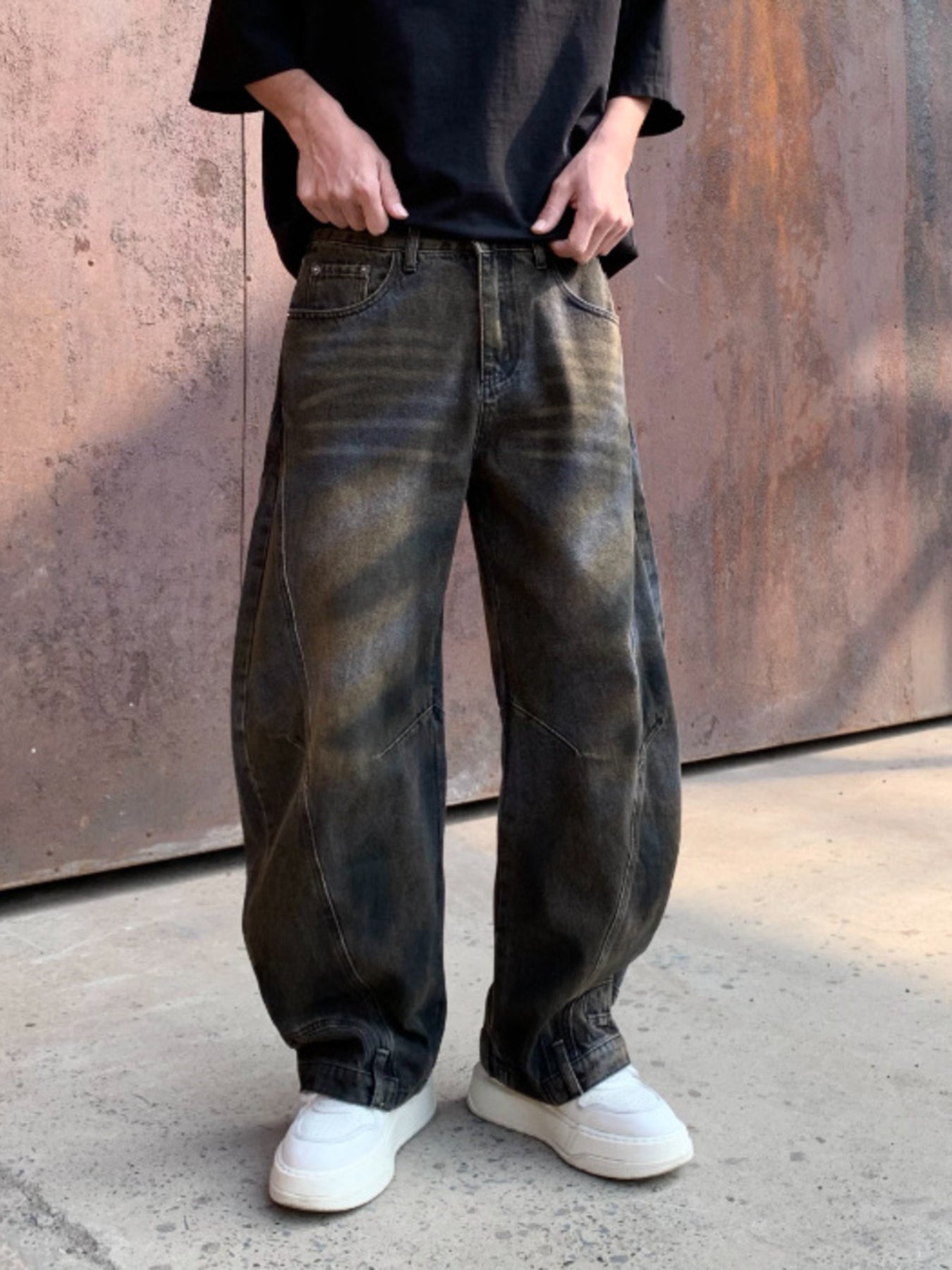 Men's black distressed wide-leg denim jeans with a relaxed fit.