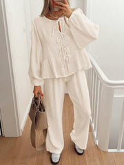 Cream textured peplum co-ord set with tie-neck blouse and wide-leg pants