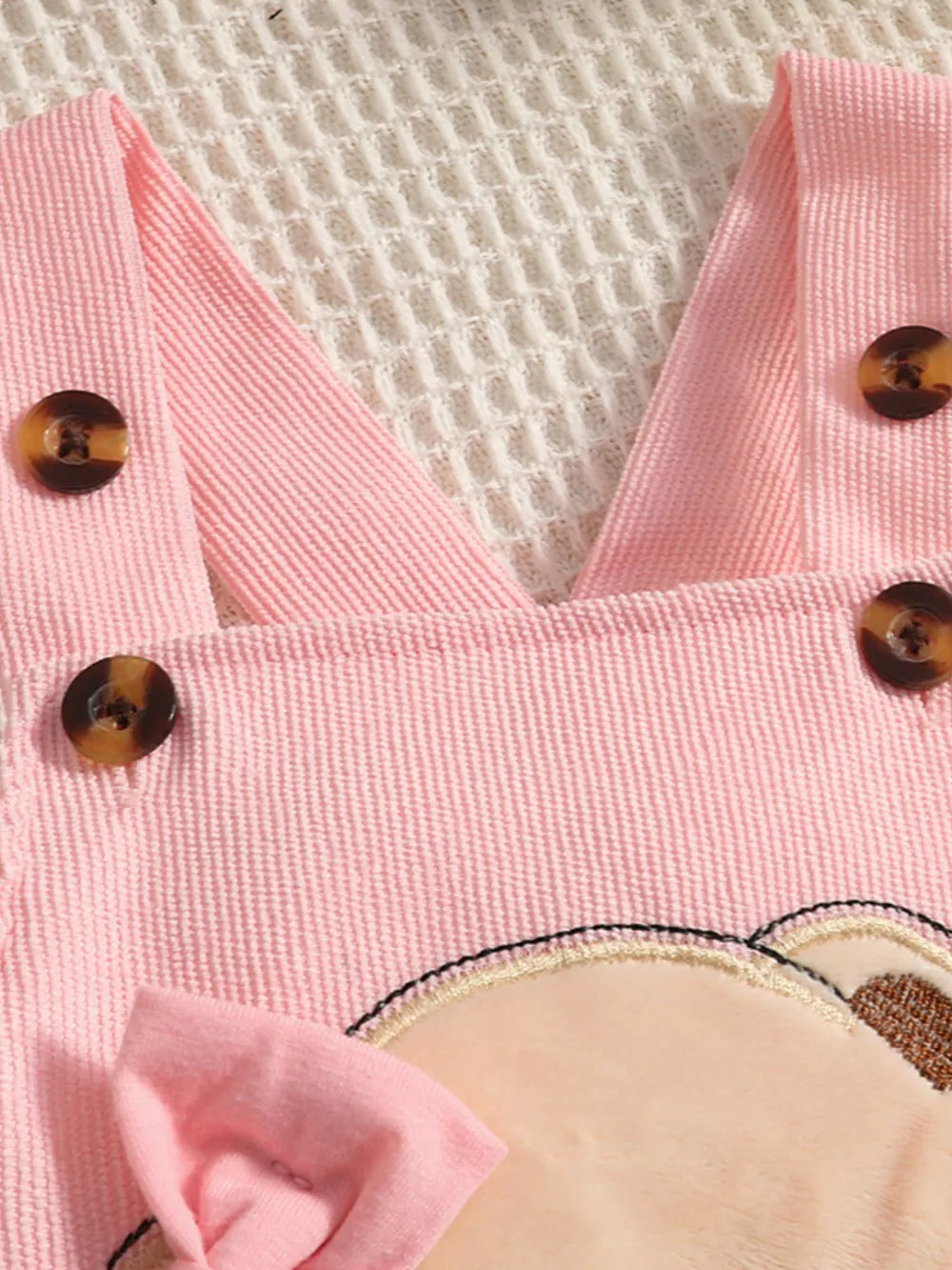 Pink corduroy baby set with bear applique and bow detail.