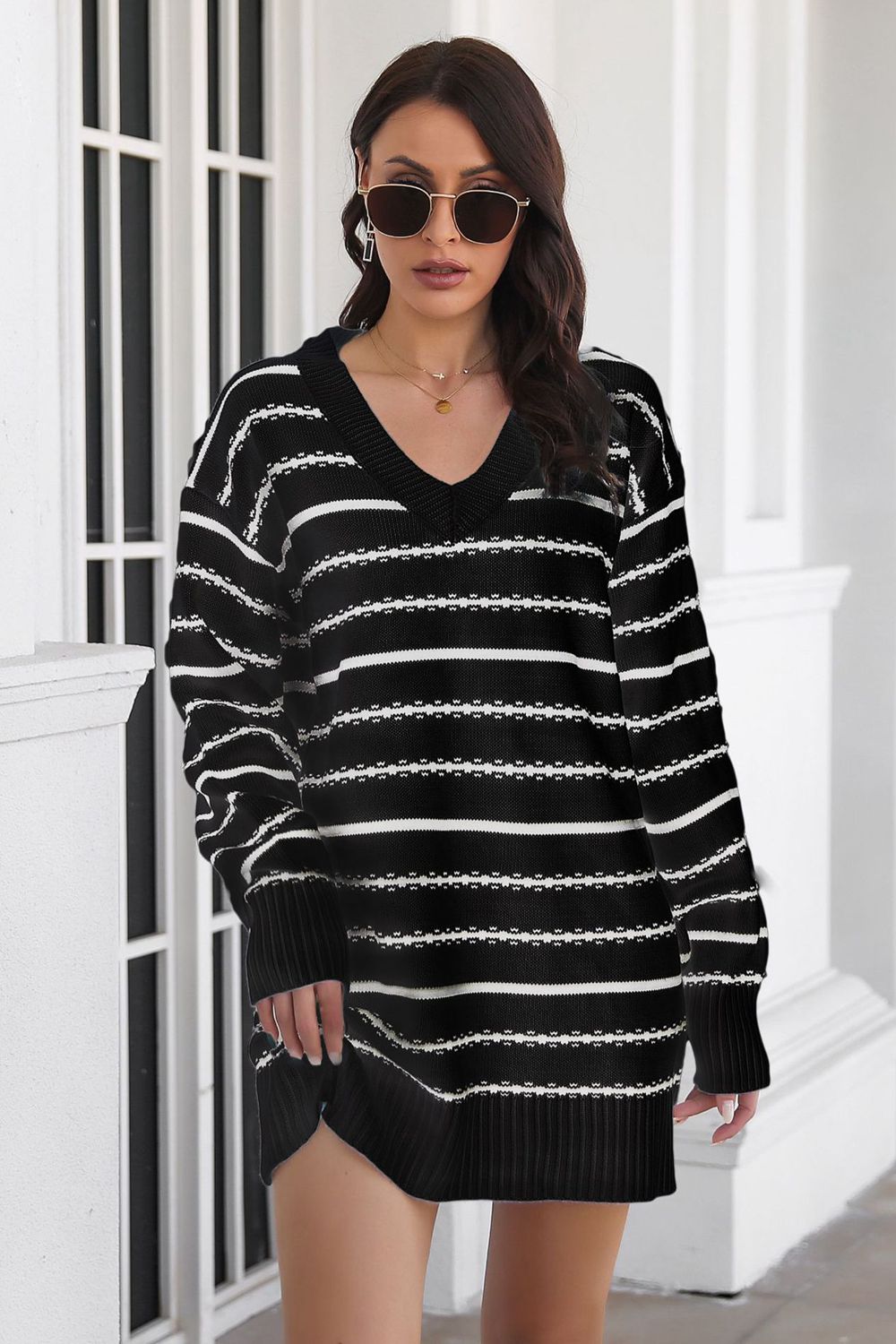 Black and white striped knit mini dress with v-neck and long sleeves