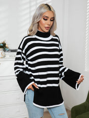 Black and white striped turtleneck sweater with flared sleeves and acrylic knit.