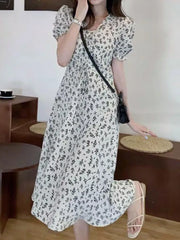 White botanical print midi dress with puff sleeves and a-line cut