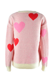 Blush pink crewneck sweater with red and pink intarsia hearts, cream ribbed cuffs and hem.
