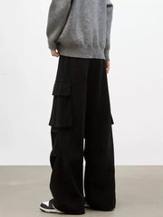 Black cargo pants with large side pockets and a relaxed fit.