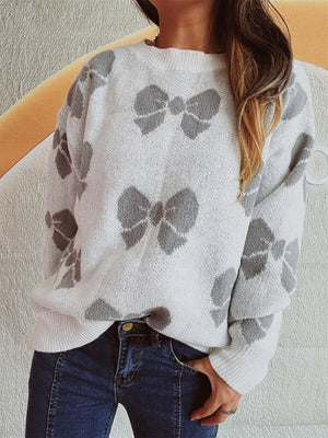 White knit sweater with all-over gray bow pattern, crew neck, relaxed fit.