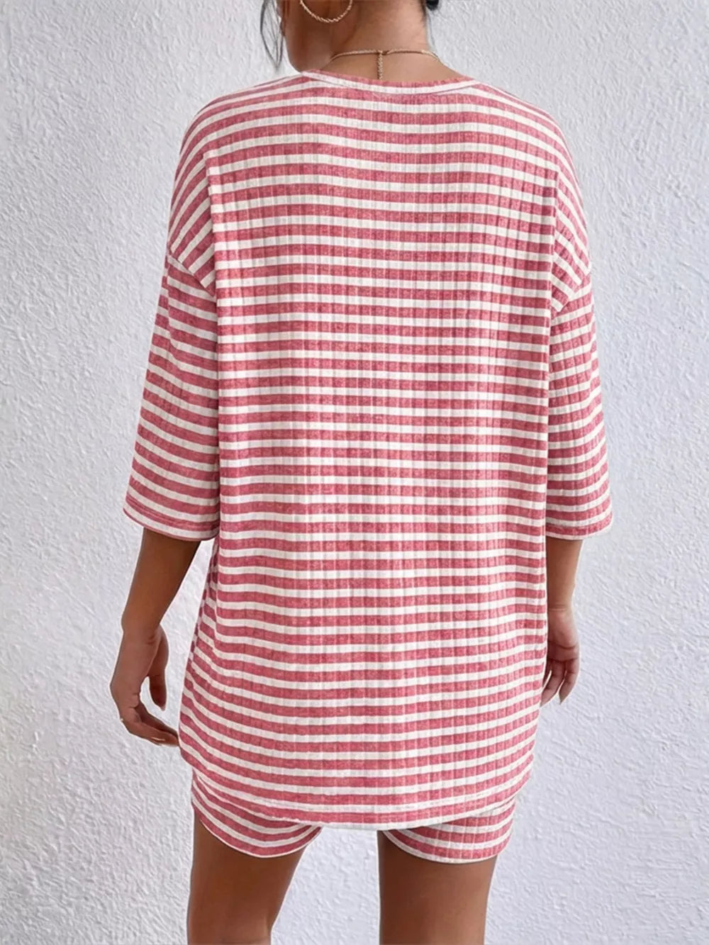 Pink striped two-piece set with elbow sleeves and shorts.