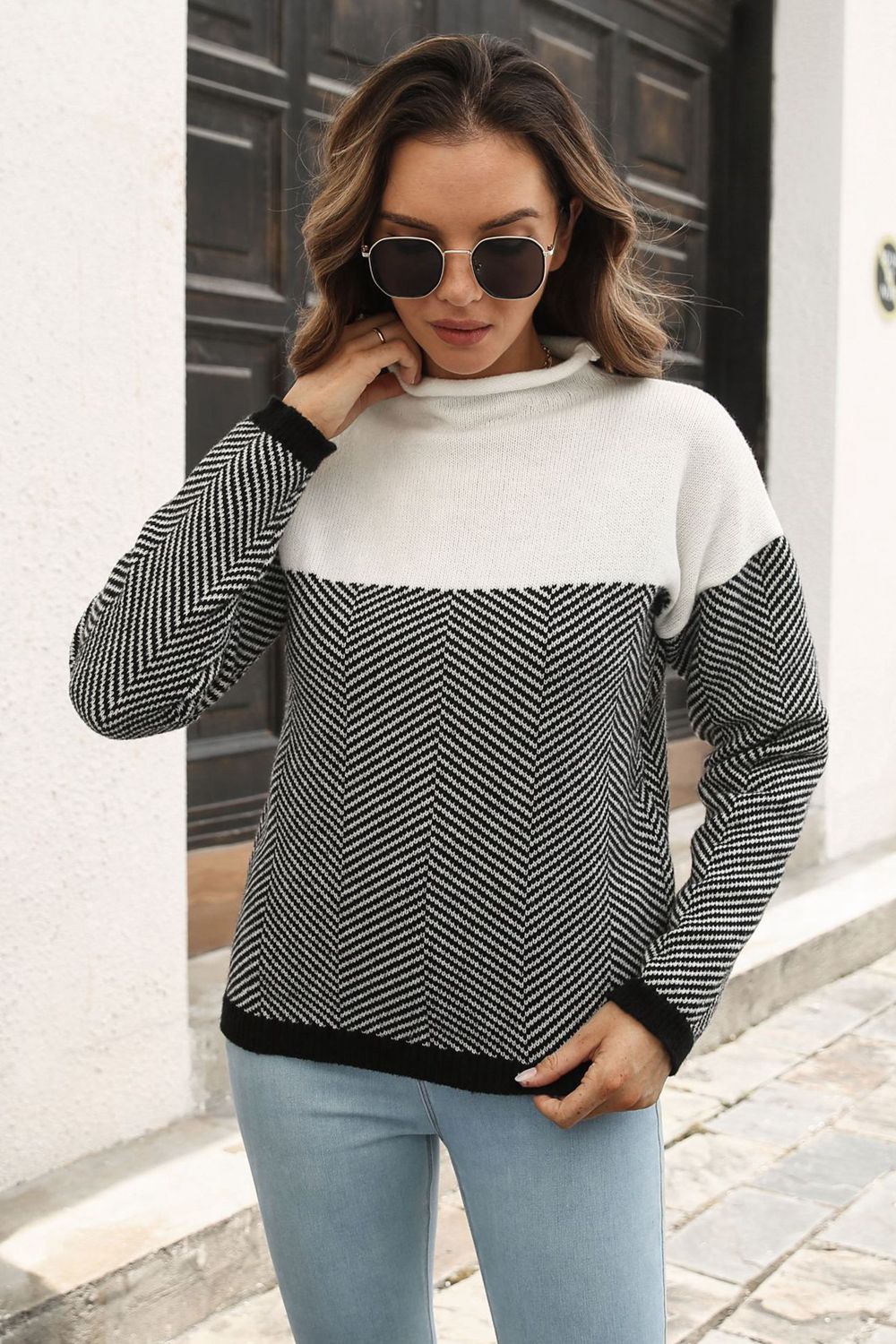 Chevron block mock neck knit sweater in black and white acrylic with a herringbone pattern.