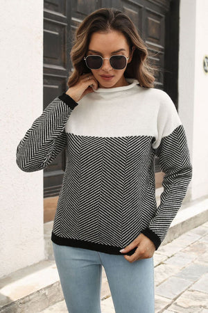 Chevron block mock neck knit sweater in black and white acrylic with a herringbone pattern.