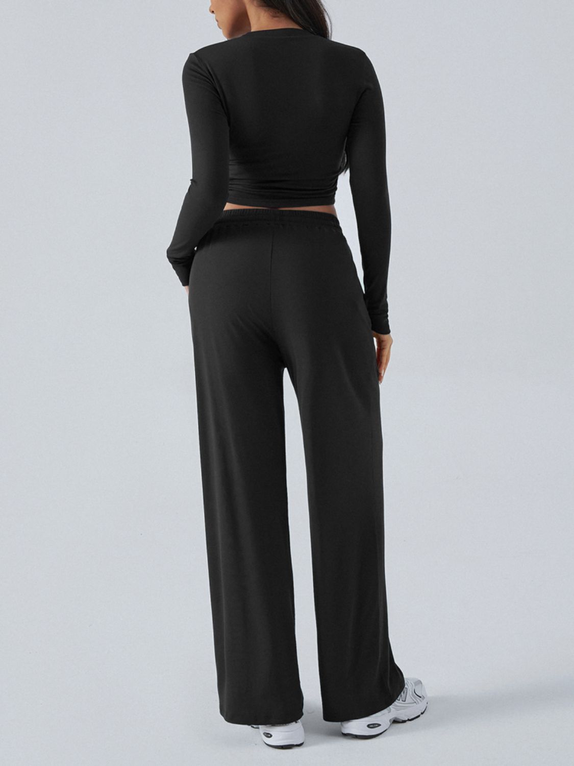 Black ribbed knit long sleeve crop top and wide leg pants set.