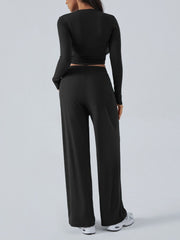 Black ribbed knit long sleeve crop top and wide leg pants set.