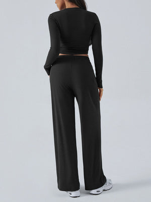 Black ribbed knit long sleeve crop top and wide leg pants set.