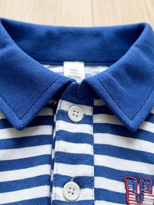 Baby blue and white striped polo shirt with red embroidered detail and white buttons.