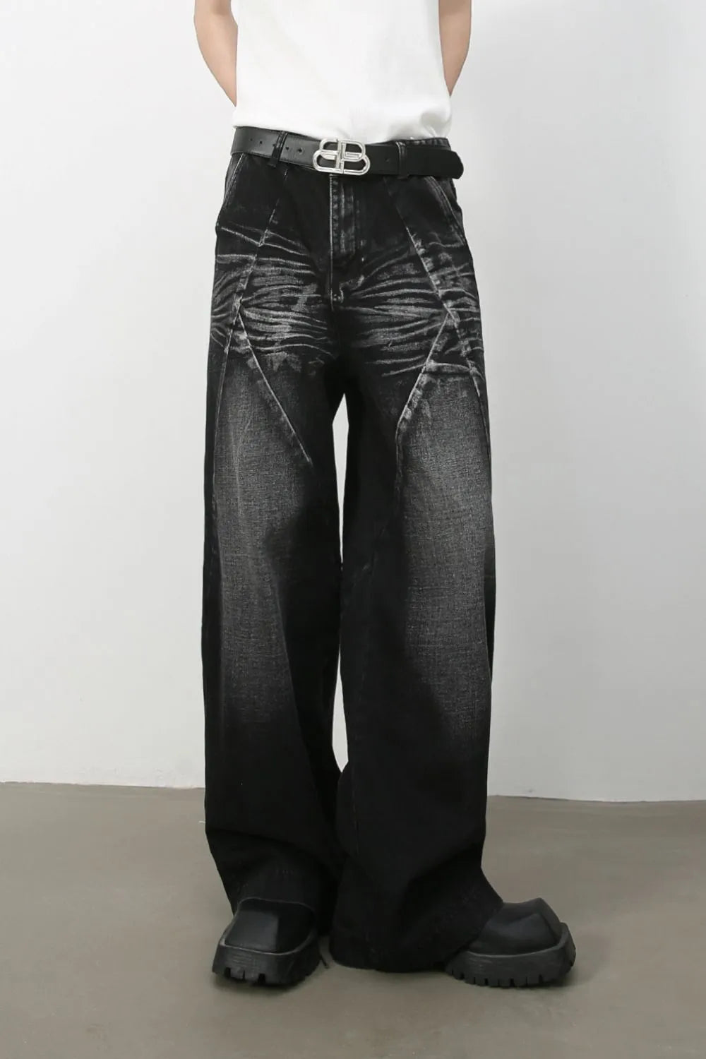 Dark wash wide leg jeans with sculpted detailing and a faded effect.