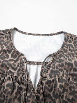 Leopard print V-neck denim blouse with tie detail.