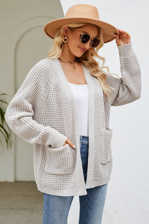 Light Gray waffle knit cardigan with patch pockets and ribbed cuffs.