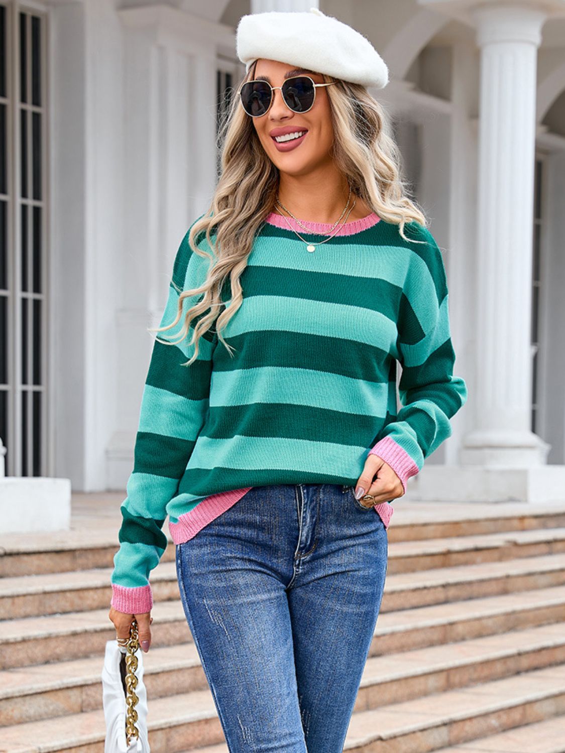 Striped knit sweater in green and turquoise with pink cuffs and neckline.
