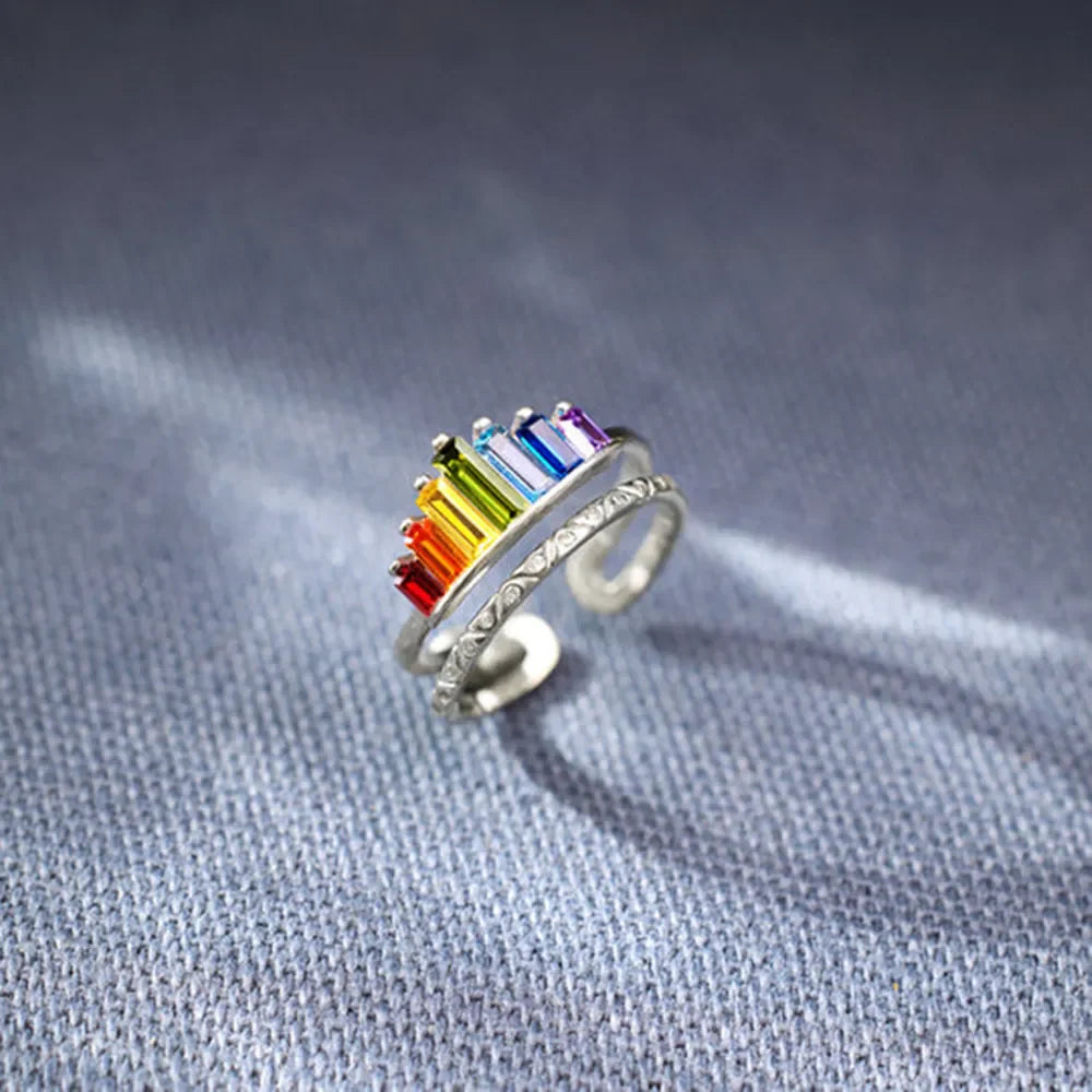 Sterling silver ring set with rainbow baguette gems and engraved band detail