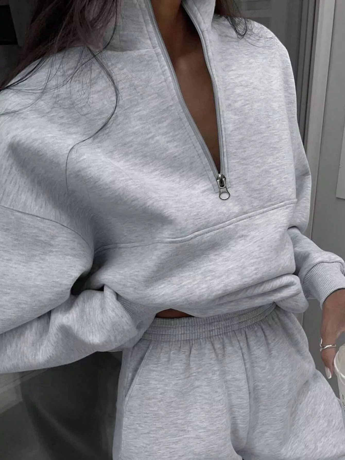 Light gray half zip sweatshirt and matching sweatpants set with a quarter zip neckline.