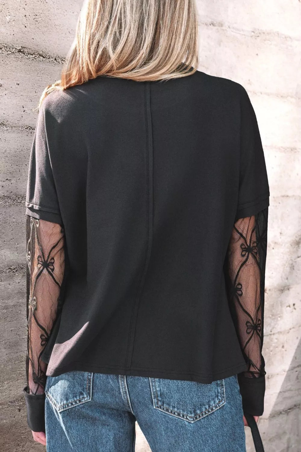 Black relaxed fit t-shirt with lace-embellished sleeves and bow detail