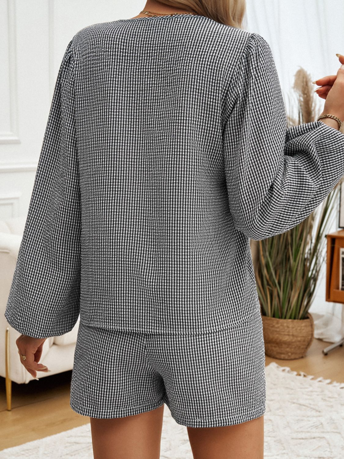 Black gingham tie-front blouse with balloon sleeves and matching shorts set.