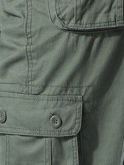Men's army green cargo pants with button flap pockets and stretch fabric detail.