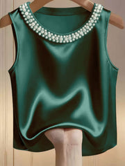 Green satin tank top with pearl embellished neckline.