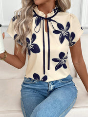 Apricot floral print blouse with frilled tie-neck and short sleeves.