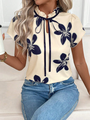 Apricot floral print blouse with frilled tie-neck and short sleeves.