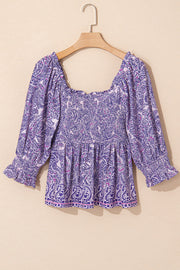 Paisley smocked bodice blouse in lavender with square neckline and ruffled cuffs.