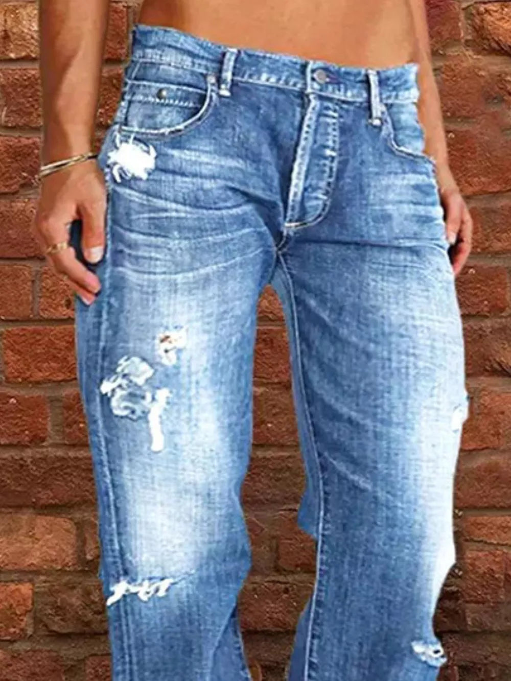 Relaxed fit light blue denim maternity jeans with distressed details and raw hem.
