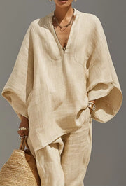 Chic relaxed beige linen two-piece set with V-neck tunic and pocket detail.