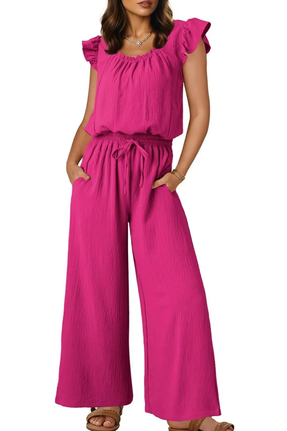 Hot Pink textured ruffle-sleeve drawstring palazzo jumpsuit with wide legs and pockets.