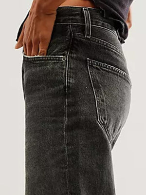 Black cuffed wide-leg denim trousers with a relaxed fit and visible pocket details.