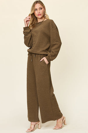 Textured lounge set in taupe with wide leg pants and crewneck sweatshirt.