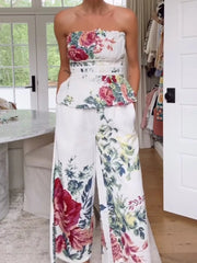Chic floral ruched strapless top and wide-leg pants set with a white polyester base.