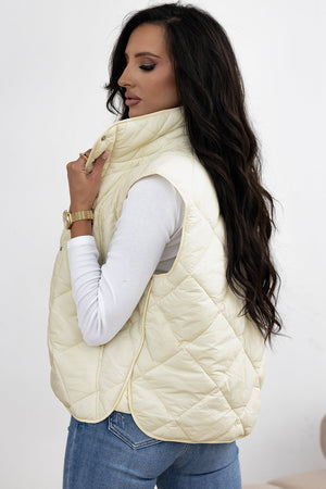 Ivory quilted stand collar vest with diamond stitching and a relaxed fit.
