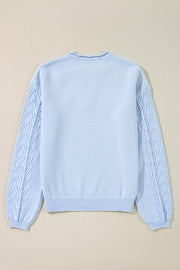 Sky blue knit sweater with textured cable sleeves and a raw hem neckline.