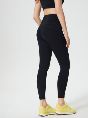 Black high-waisted leggings with contouring seam detail and pocket.
