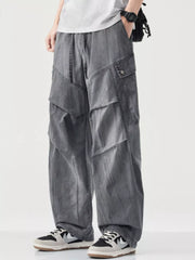 Loose fit grey cargo pants with drawstring and multiple pockets.