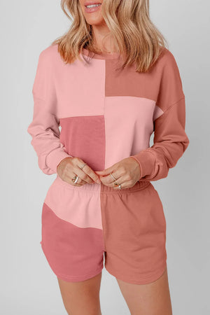Colorblock lounge set with crewneck sweatshirt and shorts in dusty pink and light blue shades.