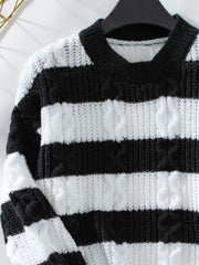 Black and white striped cable knit crewneck sweater with textured stitching.