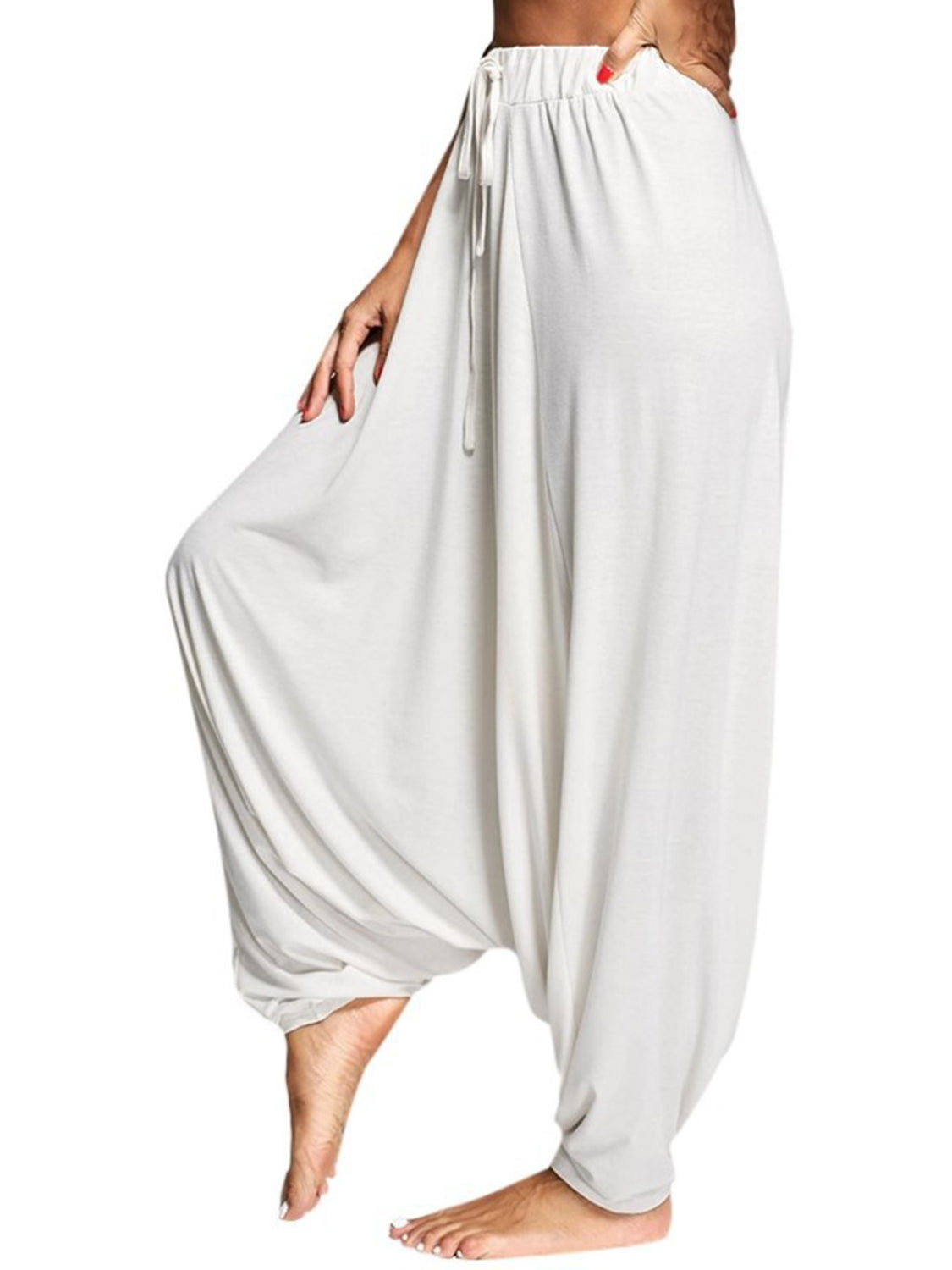 White drape-front drawstring harem pants with a relaxed fit.