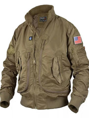 Men's taupe bomber jacket with multiple zippered pockets, patches, and ribbed cuffs.
