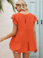 Orange babydoll blouse with ruffled sleeves and tiered hem, featuring a keyhole back detail.