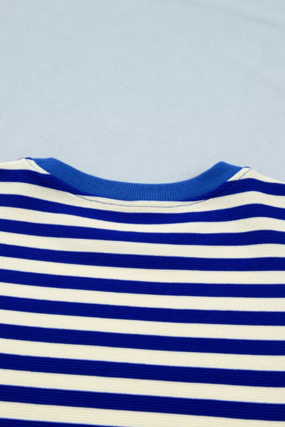 Blue and cream striped polyester top with crew neck and ruffle sleeves.