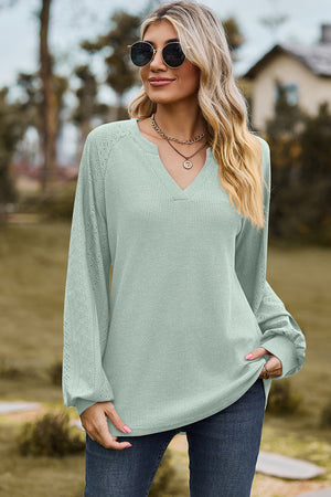 Light green waffle knit raglan V-neck top with eyelet detail on sleeves