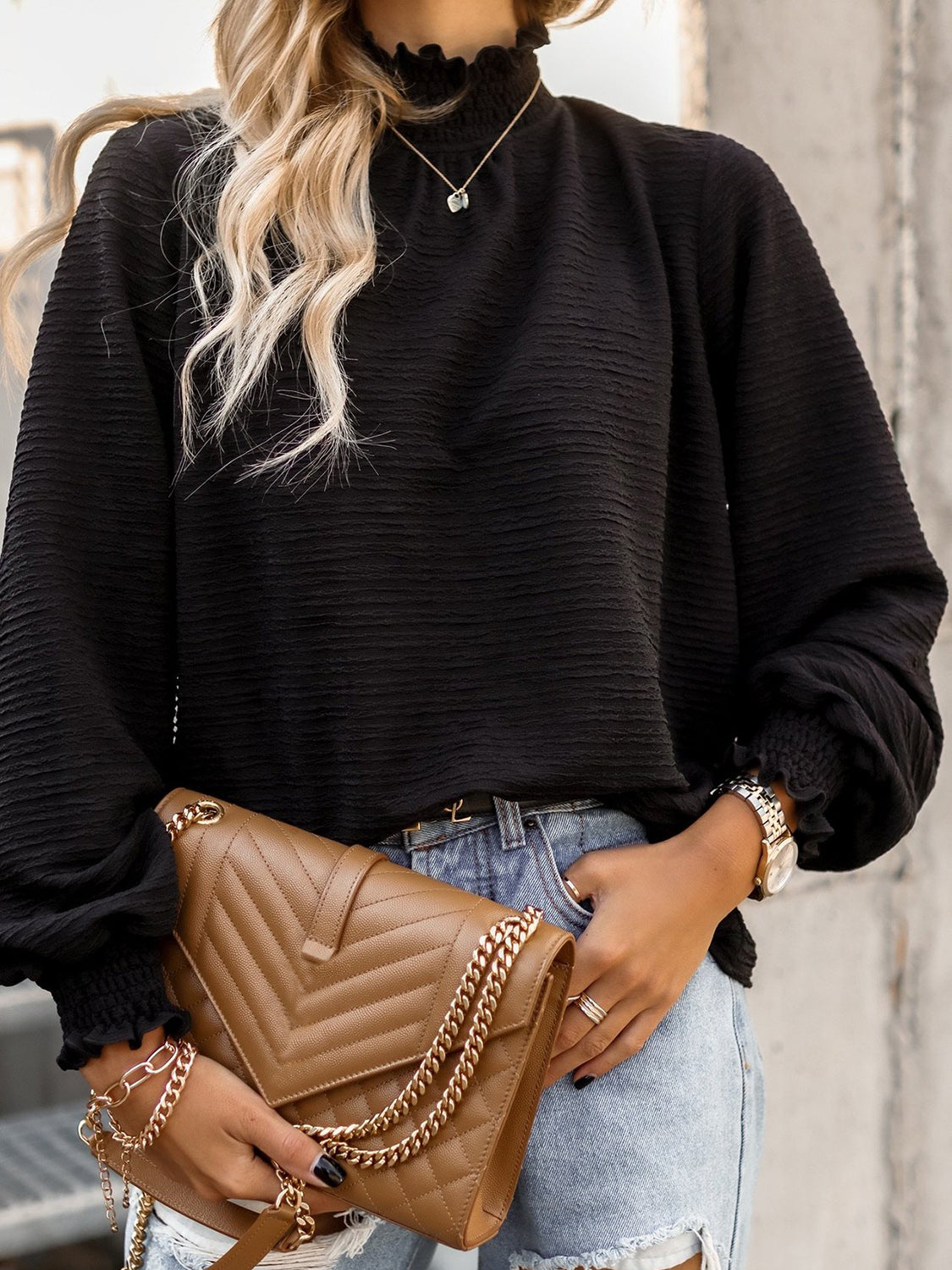 Black textured puff sleeve blouse with smocked neck and cuffs