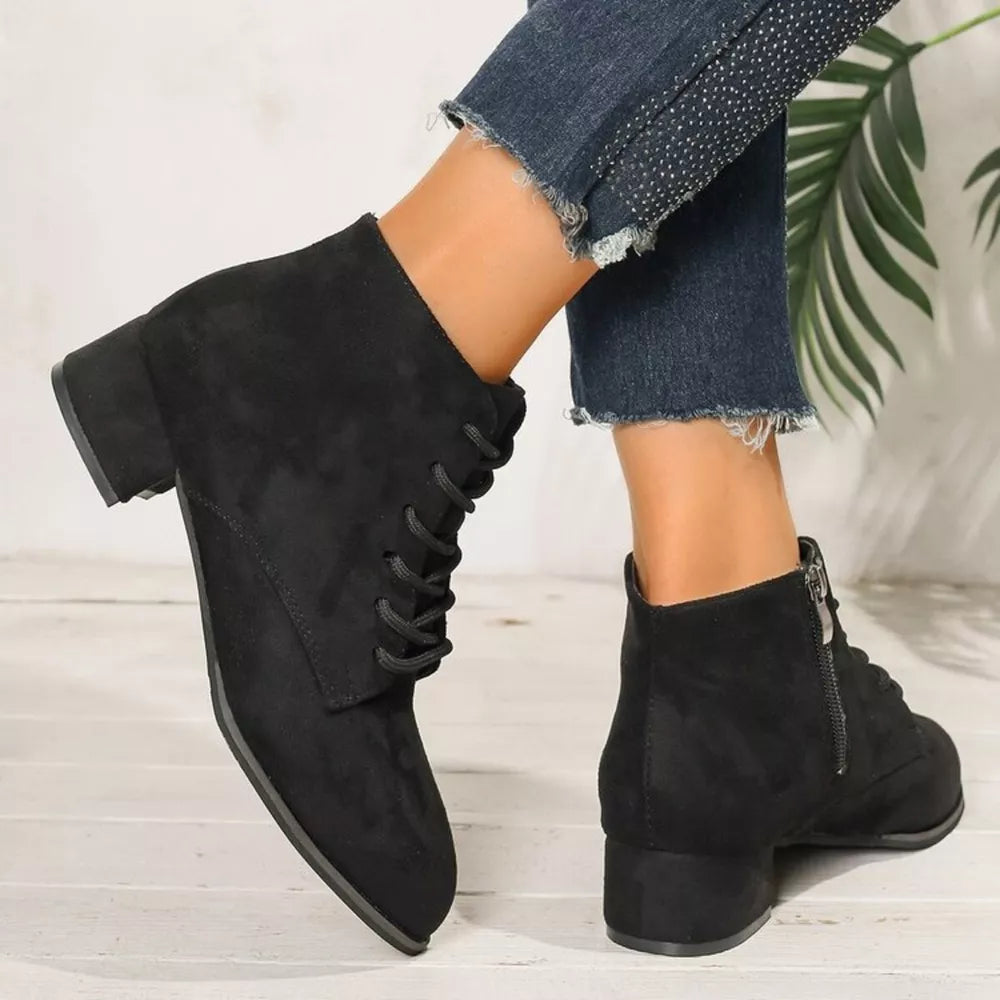 Black suede lace-up ankle boots with block heel and side zipper detail.