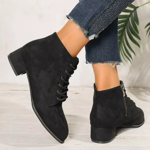 Black suede lace-up ankle boots with block heel and side zipper detail.